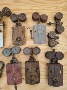 an assortment of old and rusty metal objects on a wooden surface with screws, keys, and locks