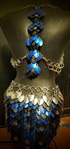 a mannequin with blue and silver chains on it