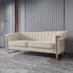 a white couch sitting on top of a tiled floor