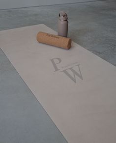 a cork with the word w on it next to a roll of paper