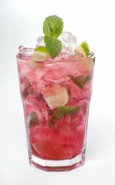 a glass filled with watermelon and mint garnish on top of ice