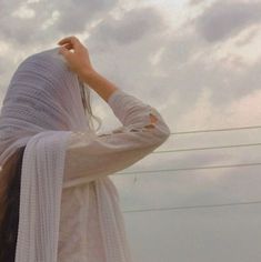 a woman with long hair wearing a white shawl