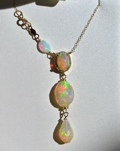 Rare opal necklace with diamond halo and drops of opals. Set in 14K solid yellow gold, chain included at 18” length. Fine Jewelry Multi-stone Opal Jewelry, Opal Multi-stone Pendant Necklace, Multi-stone Opal Fine Jewelry, Opal Multi-stone Fine Jewelry, Yellow Gold Ethiopian Opal Multi-stone Jewelry, Multi-stone Ethiopian Opal Jewelry In Yellow Gold, Ethiopian Opal Multi-stone Yellow Gold Jewelry, Ethiopian Opal Multi-stone Jewelry In Yellow Gold, Fine Jewelry With Ethiopian Opal And Gemstone Accents