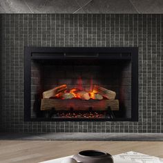 a fire place with a book and cup on the table