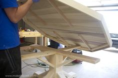 a man is working on a wooden boat