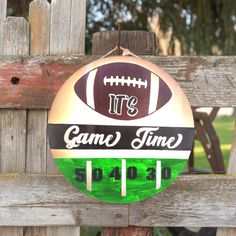 a sign that says it's game time with a football on it