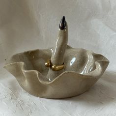 a ceramic bowl with a pen in it