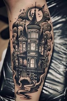 a black and white tattoo on the leg of a person with a house in the background