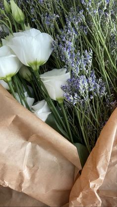 white flowers and lavenders wrapped in brown paper