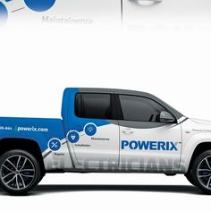 a white and blue truck parked in front of a sign that says powerix on it