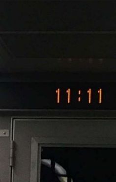 an exit sign with the time 11 11 on it