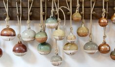 an assortment of ceramic ornaments hanging from ropes