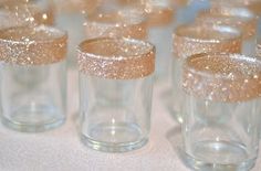 there are many glasses with gold glitter on them