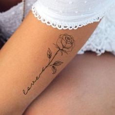 a woman's arm with a tattoo on it that says love and a rose