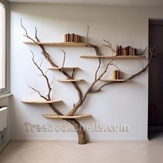 a tree branch with books on it in a room