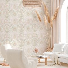 a living room with white furniture and wallpaper