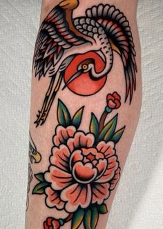 a woman's leg with flowers and birds on it