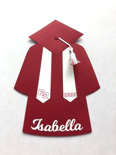 a red graduation gown with white tassels and a name tag attached to it