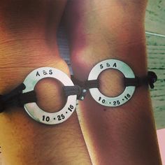 two people wearing bracelets with numbers on them