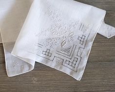 10% Off 2 or More Code SAVE10 Vintage Wedding Handkerchief ~ This all white hankie features floral Madeira style embroidery and fancy drawn-thread details on one corner.  There are tiny flowers on each of the other corners. The white satin embroidery is exceptional. It is made of  soft cotton and has a hand-rolled hem. A perfect 'something old' something beautiful for the bride!  Measures 12 x 12 inches Thanks for visiting → RoseAnaDana.Etsy.com . Traditional White Handkerchiefs With Floral Embroidery, Formal White Embroidered Handkerchiefs, Elegant White Handkerchiefs With Machine Embroidery, Classic White Embroidered Handkerchiefs, Elegant White Handkerchiefs With Floral Embroidery, Elegant White Floral Embroidered Handkerchiefs, Satin Embroidery, Embroidery Vintage, Drawn Thread