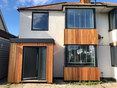 a white house with wooden siding and windows