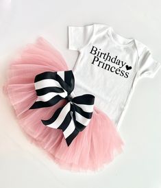 This full tutu has ten layers with a wide elastic band inside to keep the itchy tulle off your little ones' skin. The multiple soft layers give a fluffy look but lays perfectly. The bow can clip onto the tutu for your desired look. OPTIONS AVAILABLE FOR PURCHASE: Bodysuit/ Shirt Tutu with removable bow Crown Tutus are perfect for birthdays, weddings, holidays, and every day! Our tutus are super stretchy and can grow with your child. Please message me if you have any questions about sizing or col Princess Style Birthday Tutu Dress, Princess Style Birthday Tutu Dress With Tulle Skirt, Cute Fitted Tutu Dress For Birthday, Black Princess Style Tutu Dress For Birthday, Fitted Tutu Dress With Tulle Skirt For Birthdays, Fitted Tulle Tutu Dress For Birthday, Fitted Tutu Dress With Tulle Skirt For Birthday, White Tulle Tutu Dress For Cake Smash, Fitted Birthday Tutu Dress With Tulle Skirt