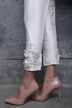 This season's must have ivory cigarette pants, are intricately embroidered using ribbon, crystal and pearl detailing creating that extravagant look. Shalwar Design For Women, Pant Plazo Design, Embroidery Trousers, Cutwork Designs, Shalwar Design, Crystal Embroidery