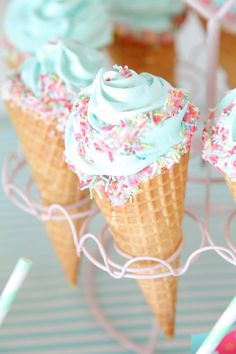 three ice cream cones with sprinkles on them