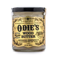 oddie's wood butter is shown in a glass jar on a white background