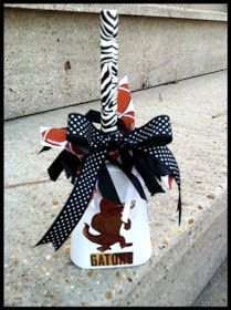 a zebra print umbrella on the sidewalk with black and white ribbon tied around it's pole