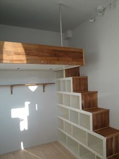 an instagramted photo of a loft bed with built - in bookshelves