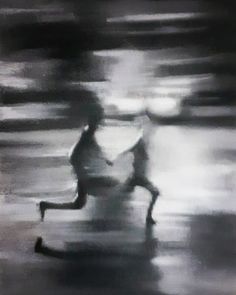 a blurry image of two people running in the rain