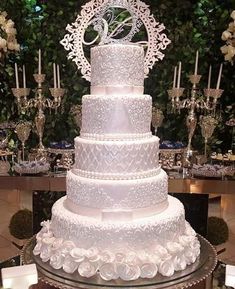 a large white wedding cake sitting on top of a table