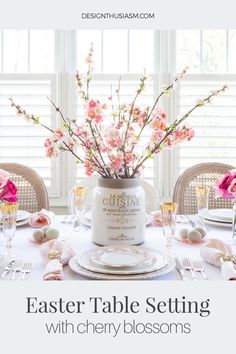 an easter table setting with pink flowers in a vase and place settings on the table