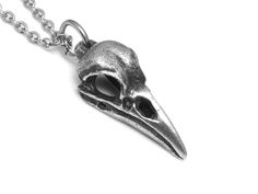 This dark Raven Skull Necklace has been heavily oxidized and then brushed with steel wool in order to get an aged antique finish. It differs quite a lot from the polished version that you can find over here: https://www.etsy.com/listing/266863085/small-raven-skull-necklace-handmade The bird skull design is carved by hand in wax. We have cast it in Lead Free Pewter and it has a weight of 6 grams and is just over an inch long (27 mm). It is delivered with a Stainless Steel chain. We also have a to Hummingbird Skull, Bird Skull Jewelry, Bird Skull Necklace, Raven Skull Necklace, Pewter Jewelry, Animal Skull, Skull Pendant Necklace, Raven Skull, Bird Skull