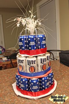 a cake made to look like beer cans stacked on top of each other with fireworks