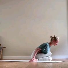 a woman is doing yoga on the floor