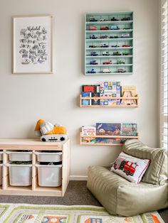 a child's room with bookshelves and toys on the wall above it