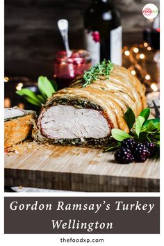 gordon ramsay's turkey wellington on a cutting board with berries and wine in the background