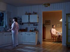 two people standing in a kitchen at night