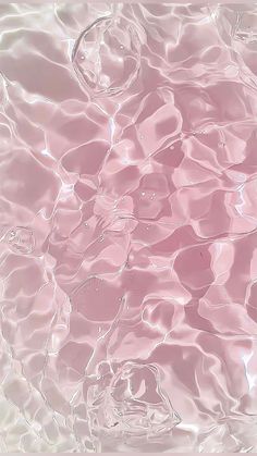 an abstract photo of water and bubbles in pink hued light blue, white and black