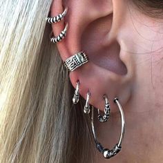 an ear with three different types of piercings on it's sides and the words,