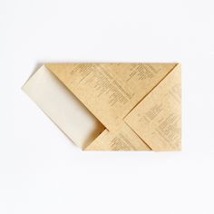 an origami piece is folded in gold paper