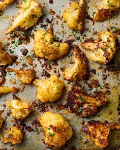 roasted cauliflower on a baking sheet with parmesan cheese and seasoning