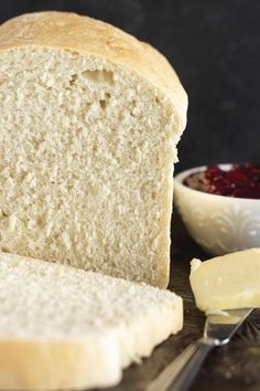 a loaf of white bread with butter and jam