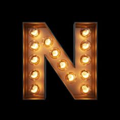 the letter n is made up of light bulbs and has been placed in front of a black background