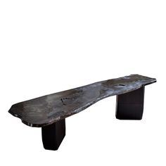 a metal bench sitting on top of a wooden table