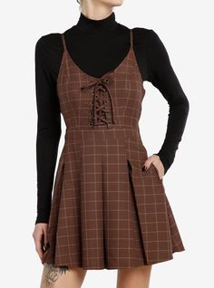 Class is in session! Get the dark academia look with this twofer dress! Featuring a brown plaid dress with lace-up detailing at the chest and a pleated skirt. Comes with a black mock neck long-sleeve underneath  adjustable straps  side zipper and pockets.Please note: Dress is fitted with no stretch; size up for a looser fit.65% polyester; 35% rayonWash cold; dry lowLength: 35''ImportedListed in junior sizesModel is 5'10''Model wears size Small Brown Plaid Dress, Dark Academia Dress, Social Collision, Academia Look, Dark Academia Look, Cutesy Outfit, Twofer Dress, Luanna Perez, Dark Academia Outfit