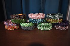 several different colored bracelets sitting on top of a table