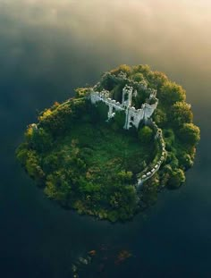 an island in the middle of water with a castle on it